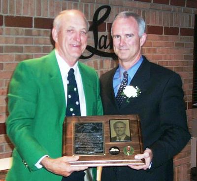 Michael O'Malley and a man holding a plaque.